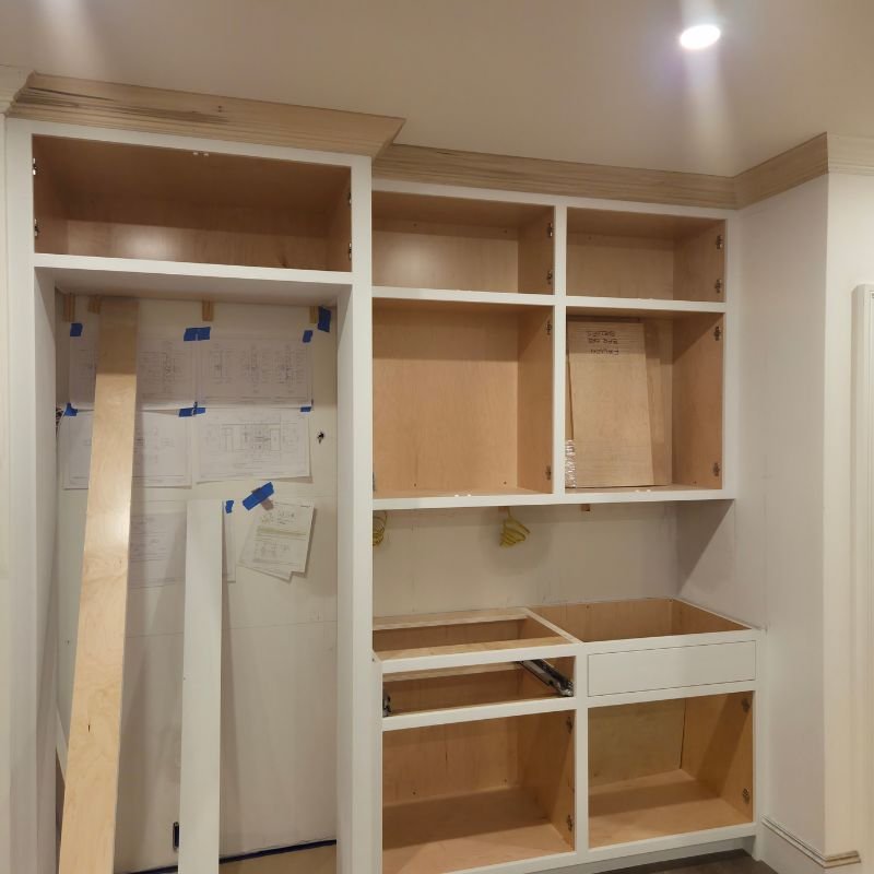 Built-in bar cabinet with glass shelving and integrated lighting